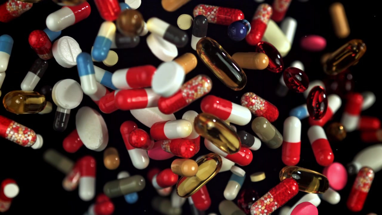 Colorful Pills, Capsules, and Tablets Falling in Slow Motion