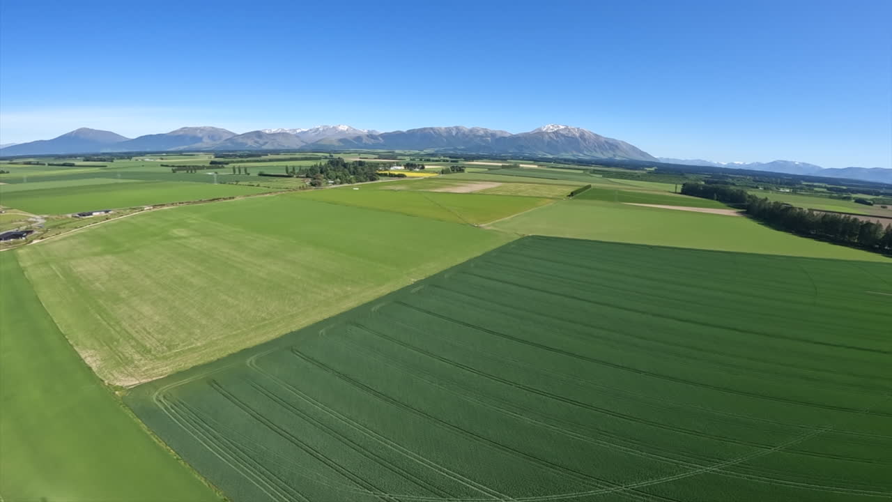 Helicopter Shot Flying Over Green Fields and Pastures Near Methven, New Zealand