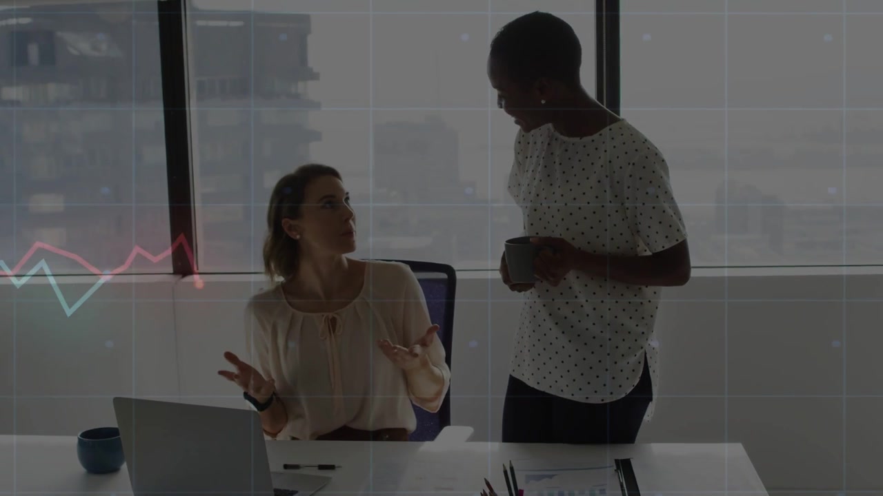 Vertical video: Seated woman showing charts in office, peer coming with mug and graph on window