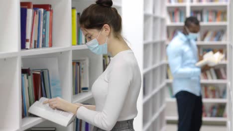 students reading in a library during a pandemic