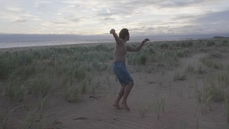 dancing on the beach in the grass