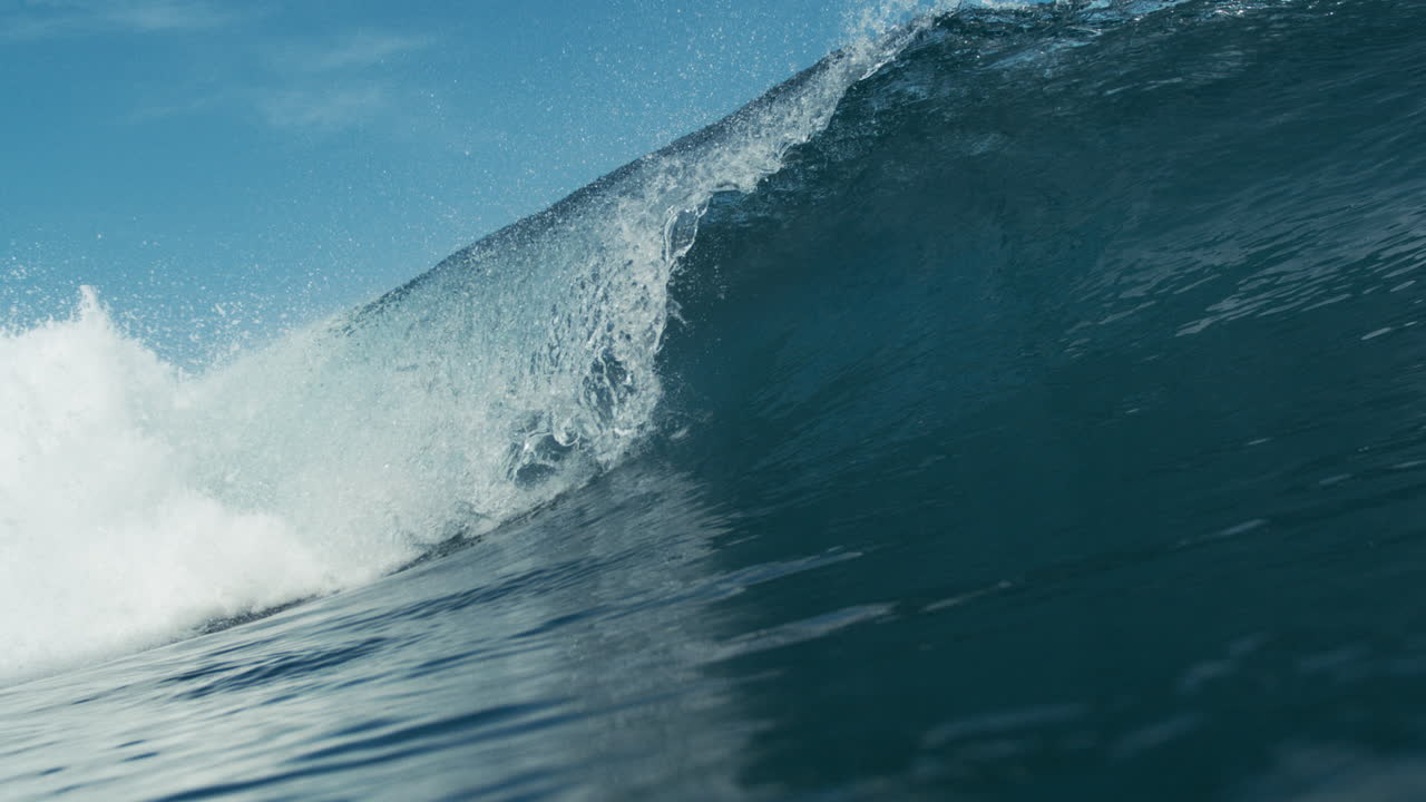 Wave crashes from left to right across screen in powerful sweeping motion