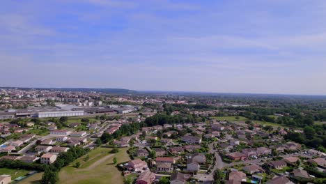 outskirts of montauban southern france with residential and industrial areas, aerial pan right shot