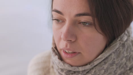 Sick-Woman-With-A-Warm-Scarf-Around-Neck-Sneezing