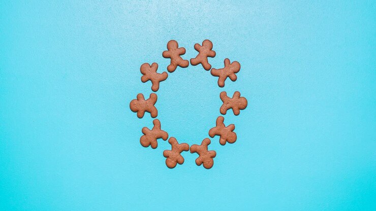 Gingerbread man cookies moving on a blue table, stop motion animation