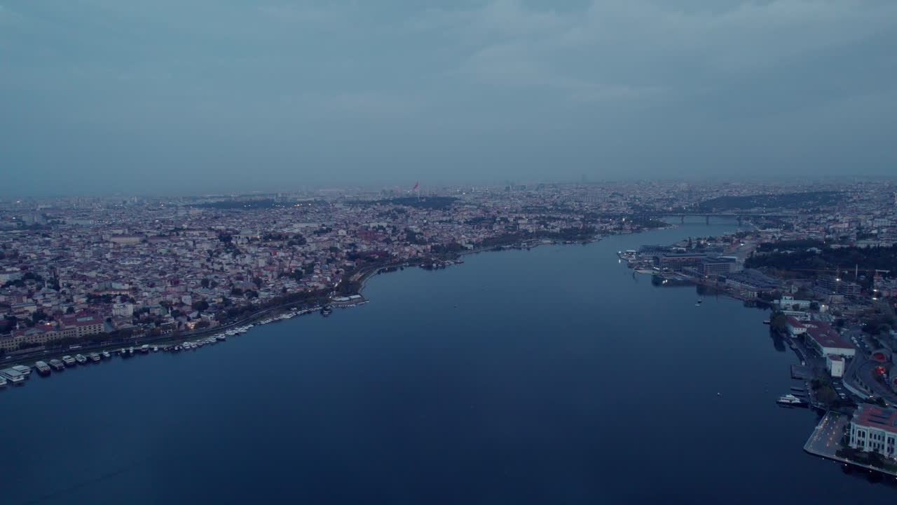 The blue river of Istanbul and cityscape on both sides on a cloudy day in Turkey, copy space and slowmotion