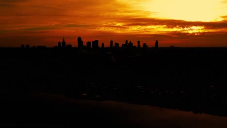 Beautiful-panoramic-aerial-drone-skyline-sunset-view-of-the-Warsaw-City-Centre-with-skyscrapers-of-the-Warsaw-City-and-Warsaw's-old-town-with-a-market-square-and-a-mermaid-statue,-Poland,-EU