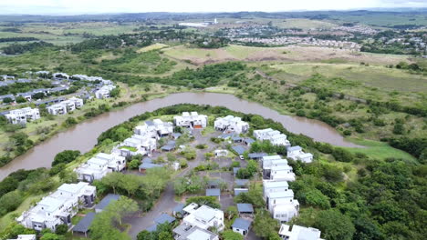 Drone-pan-down-estate-with-lake-and-apartment-buildings