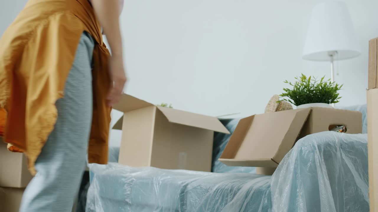 Woman moving into a new home, unpacking boxes