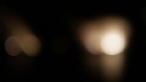 bokeh yellow lens flare on black background. flickering light bulbs, light effect. spotlight in the dark.