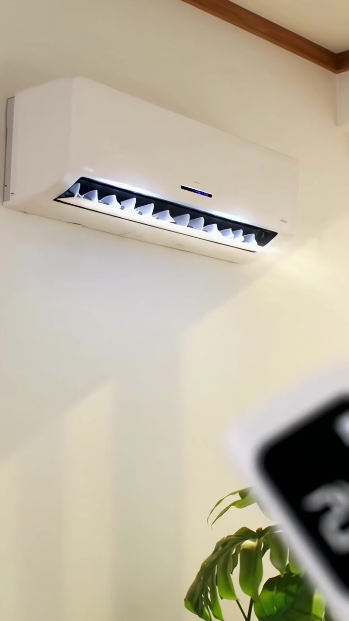 Hand Adjusting Air Conditioner Temperature with Remote Control in Modern Home