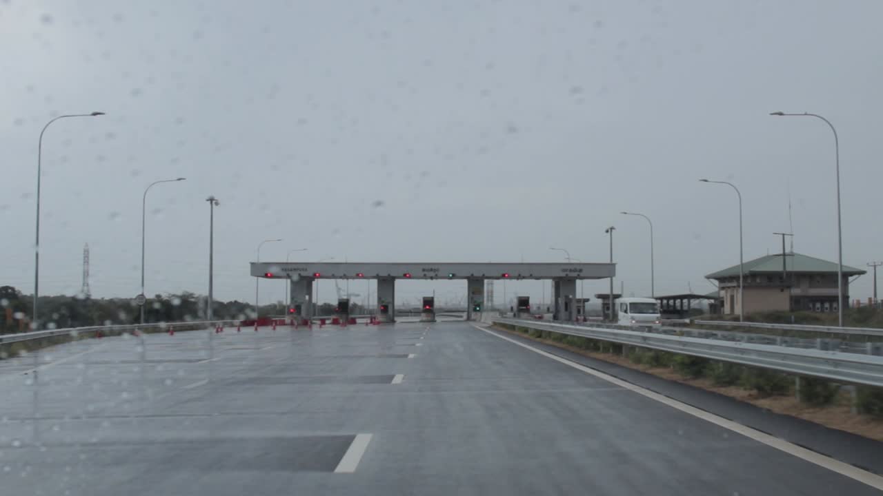 Zero Traffic at Highway toll booth in raining condition Driving closer to the exit.