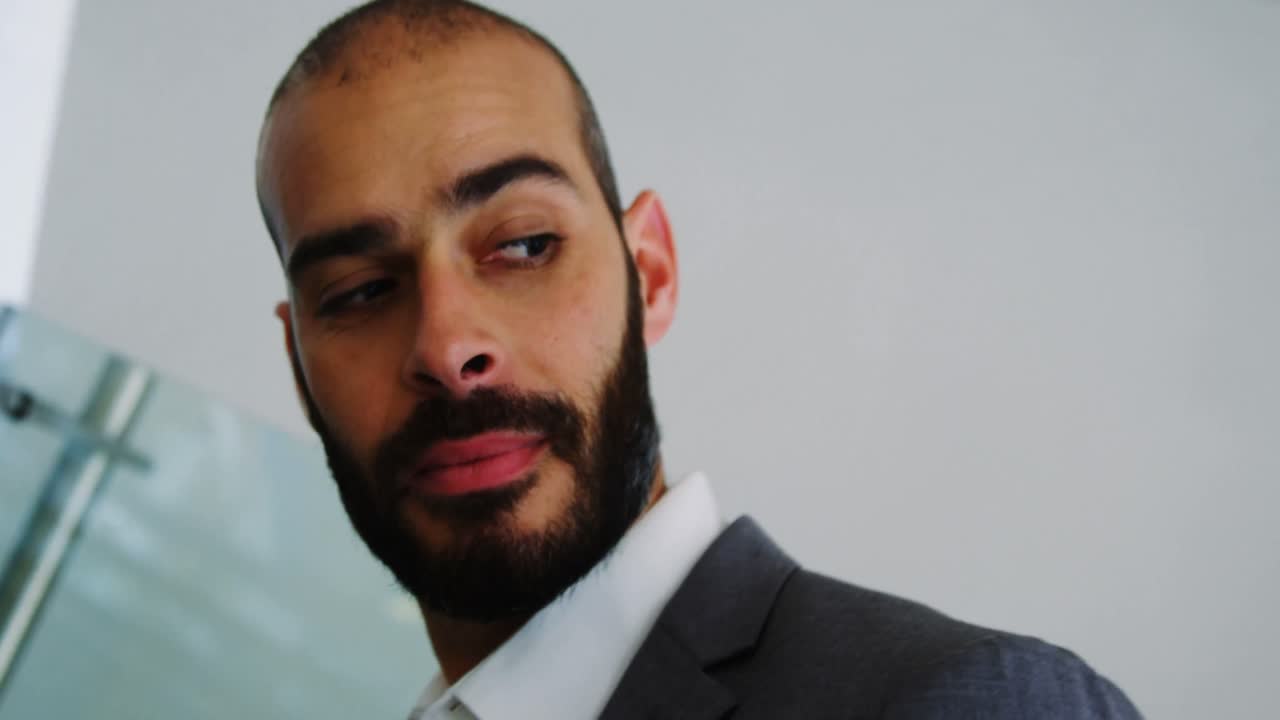 Businessman standing on an escalator