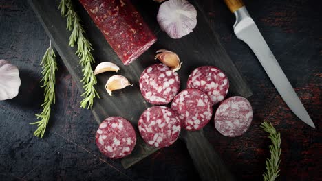 pieces of salami with garlic and rosemary slowly rotate.