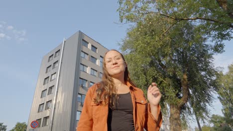 Casual-Woman-Smiles-and-transitions-to-Thinking,-in-front-of-Office-Building