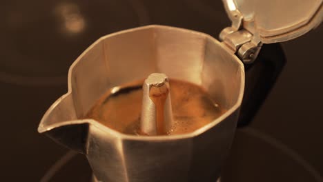 making espresso coffe in moka pot - fast motion, closeup