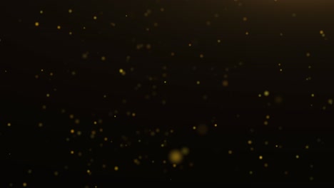 golden defocused particles on dark background - 4k loop