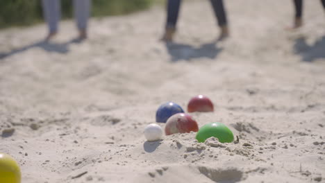 close-up view of colorful petanque balls on the sand on the beach