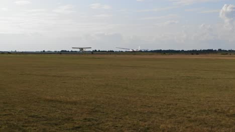 light aircraft and glider activity on a grassy airfield