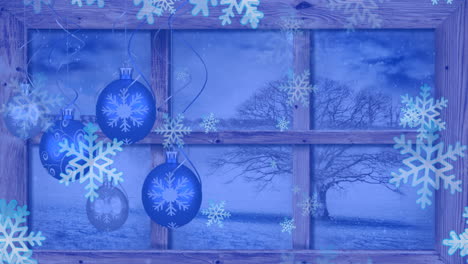animation of snow falling over christmas baubles decoration and winter scenery