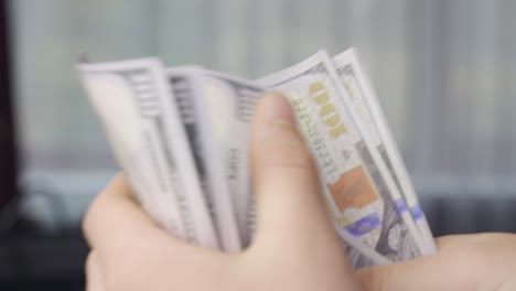 close-up male hands counting money.