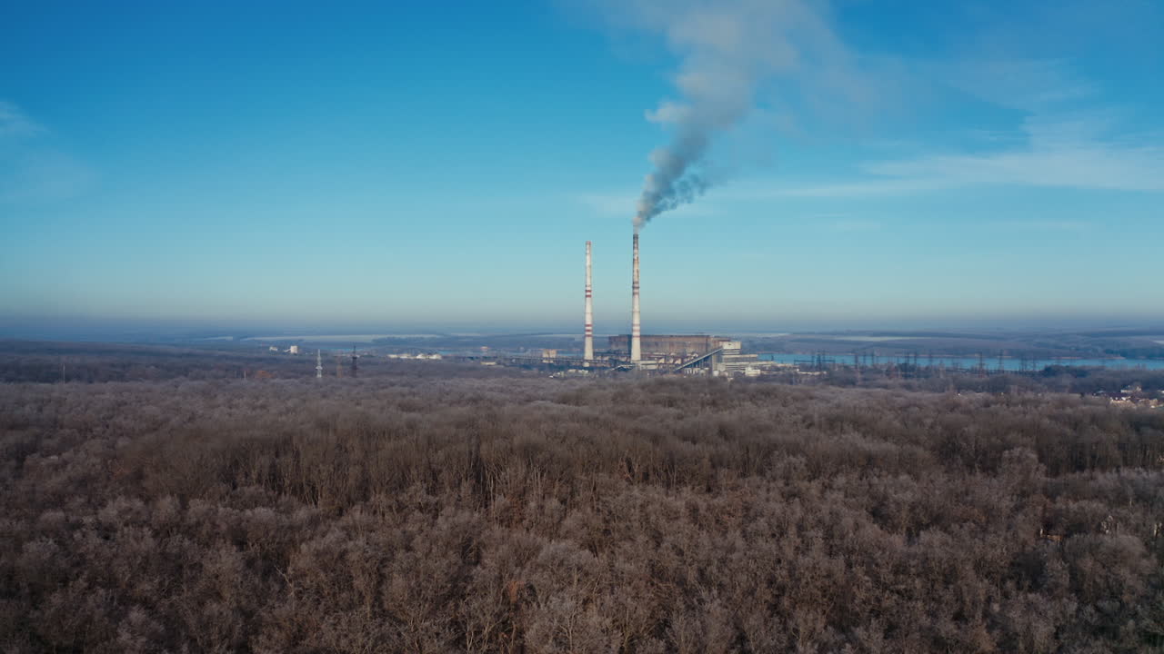 Aerial view of industrial zone. Air pollution by smoke coming out of two factory chimneys