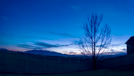 afternoon, sunset and nighttime stars and time lapse cloudscape over a suburban neighborhood