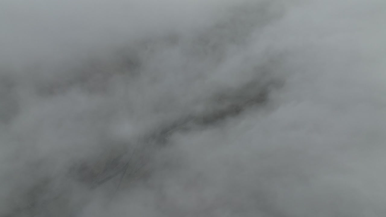 Dense fog obscures the landscape over Hafursey, Iceland, creating a mysterious and atmospheric scene.