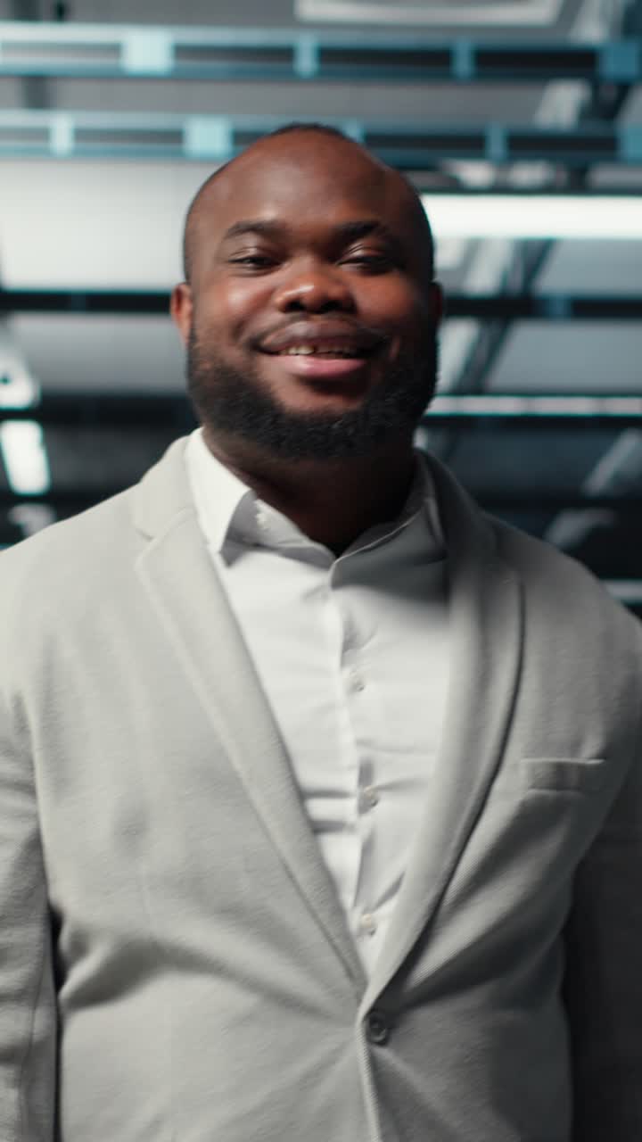 Vertical video Smiling manager in data center doing checkup on hardware to avoid downtime