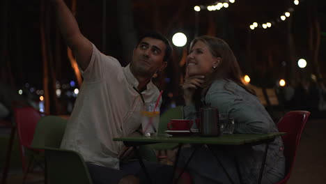 couple enjoying a romantic night out at an outdoor cafe