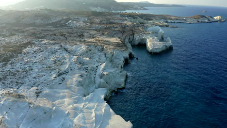 Wide-angle-Smooth-Cinematic-Aerial-Drone-footage-of-Sarakiniko-Beach-in-Milos-Island,-Greece-at-sunset-in-4K