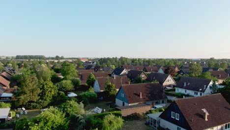 ascending aerial shot from lush garden showing housing area in staffanstorp, sweden