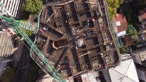 people working on top of building with crane and industrial equipment for construction site