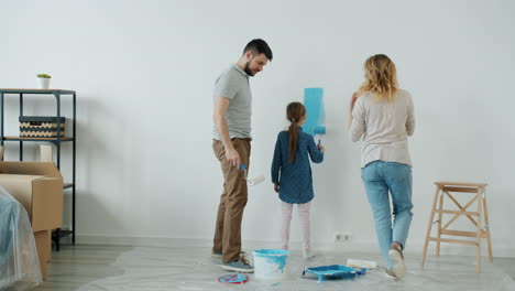 family painting a room blue