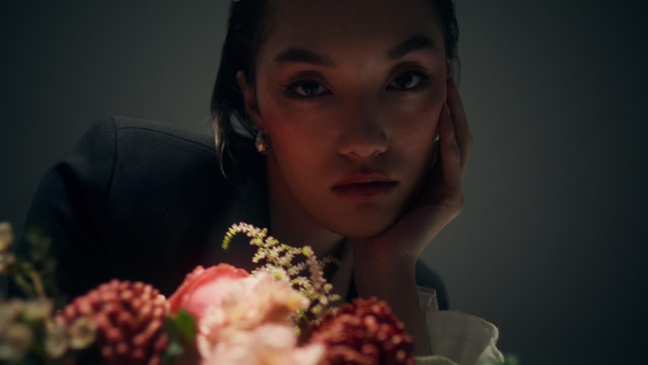 A woman with flowers in the studio