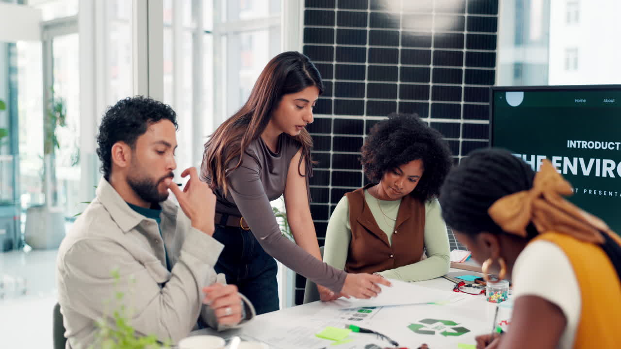 Diverse Business Team Collaborating on Environmental Project in Modern Office