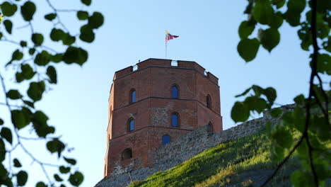 low angle static shot of gediminas tower, lithuanian flag fluttering, vilnius