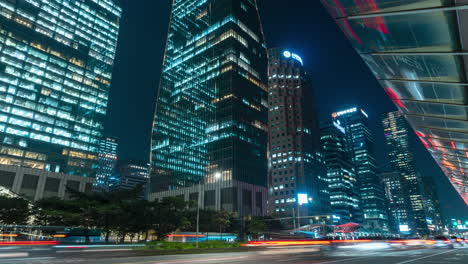 night traffic by yeouido bus transfer center and nearby office business cityscape skyscrapers , seoul, south korea - zoom out hyperlapse