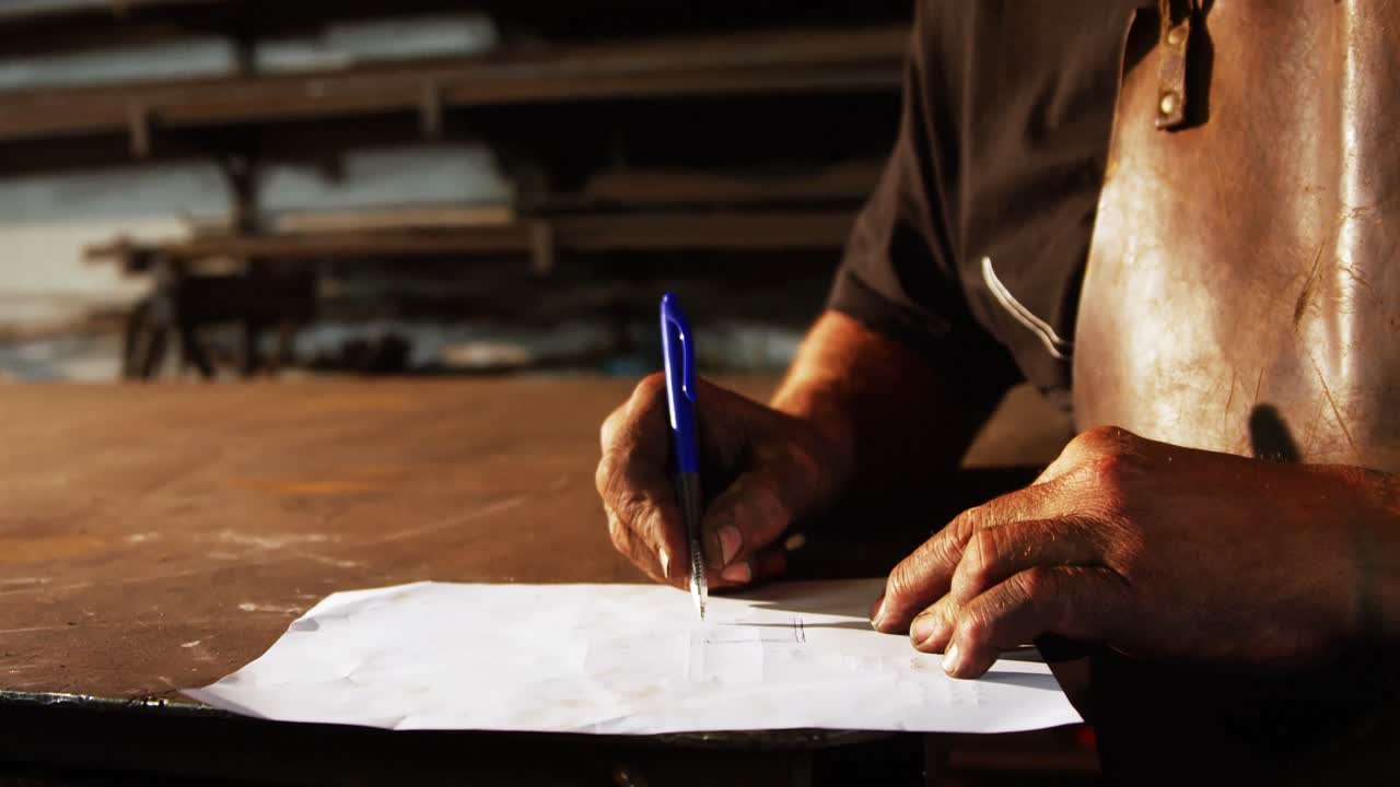 Welder working on blueprint