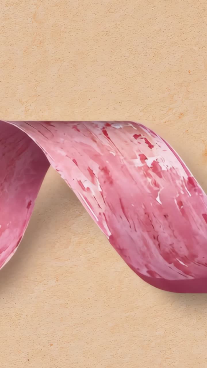 Vertical video: Sliding in from right, pink marbled ribbon looping into S-shape settling in studio