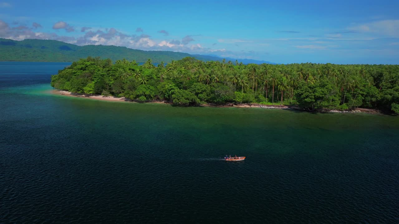 Fishing power boat Yuo Island beach shoreline remote pristine untouched tropical coastline village Wewak Madang Cape Wom Papua New Guinea aerial drone PNG East Sepik Province summer morning blue sky