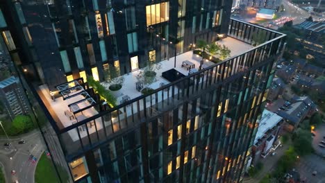 Aerial-drone-flight-around-the-balcony-of-the-Victoria-Residence-Building-in-the-early-evening-on-Deansgate-in-Manchester-City-Centre