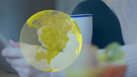 animation of globe over caucasian woman using smartphone