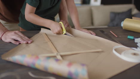 child making a kite with dad