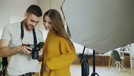 photographer teaching a model how to use a camera