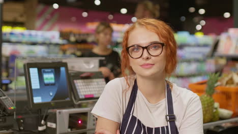 young sales clerk woman dreamily working in a supermarket