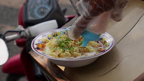 a bowl of indonesian porridge on a street vendor's cart ready to be served