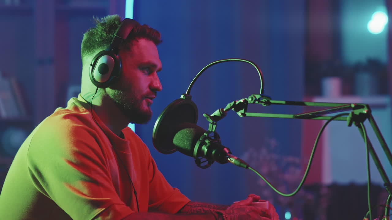 Slowmo of Man Talking into Microphone on Podcast