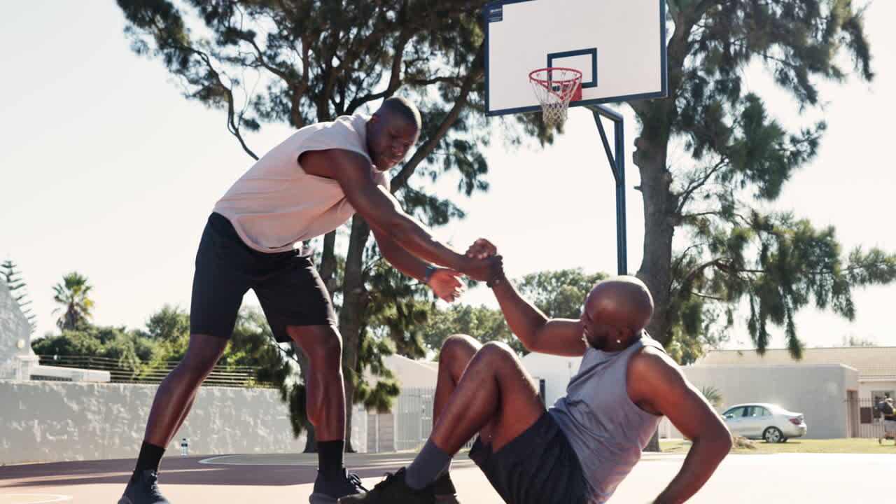 Basketball Teammates Helping Each Other on the Court