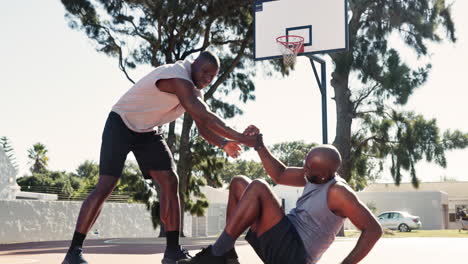 basketball teammates helping each other on the court
